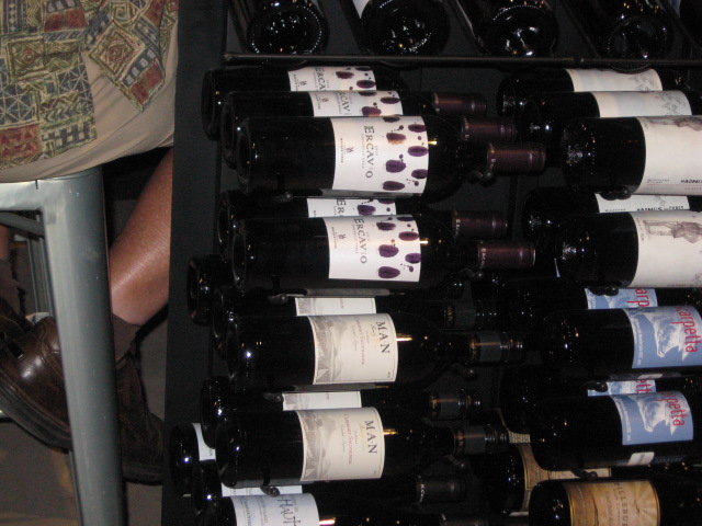 Here's a rack full of bottles of wine. Why buy one glass when you buy the bottle?