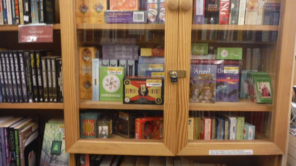 Where the  Good Stuff Is: this locked bookcase has the used and half price tarot and other cool card sets. I collect tarot decks, and I can read the cards when I want to.