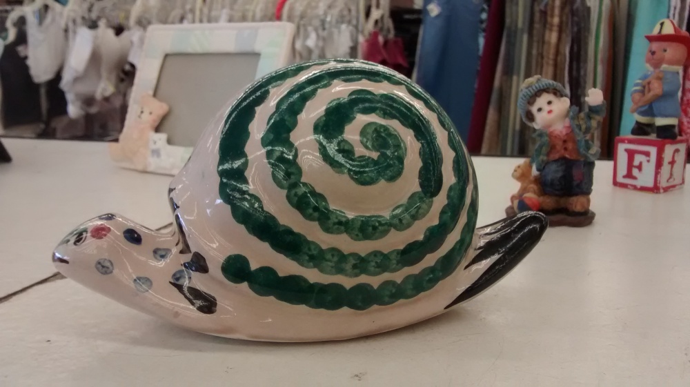 Painted porcelain snail. The other side of his shell features flowers and butterflies.