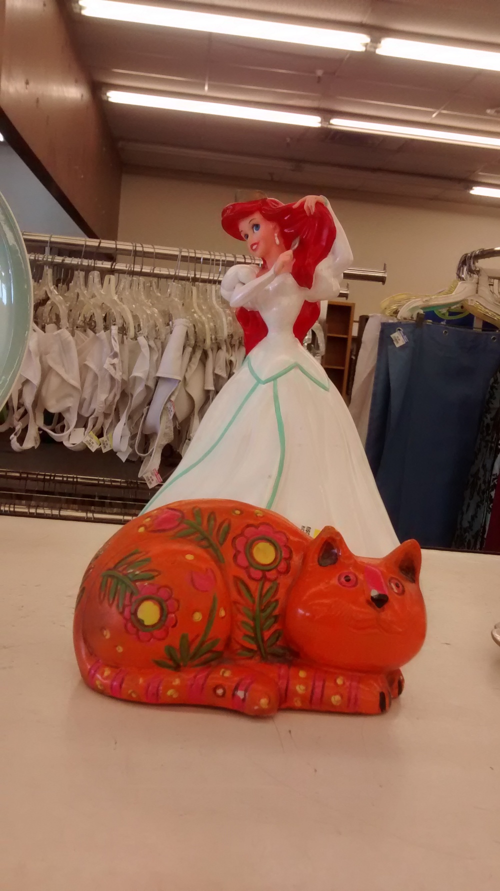 Princess Ariel in human form and the kitty. Only, this kitty is for collection coins--a kitty bank instead of a piggy bank.