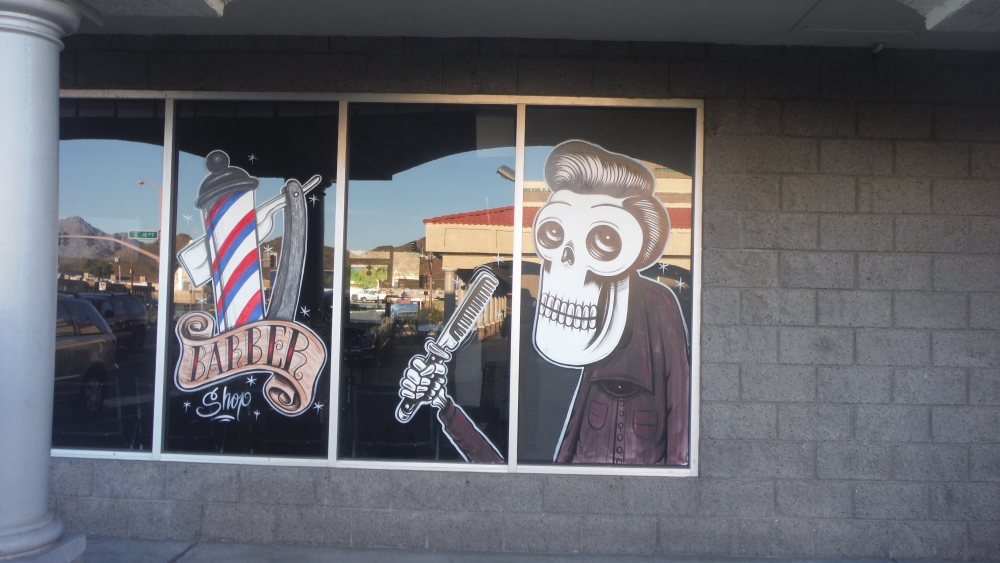 The restaurant was on the end of a little strip mall running perpendicular to the street. There were two rather bizarre businesses here--this bony barber shop . . .
